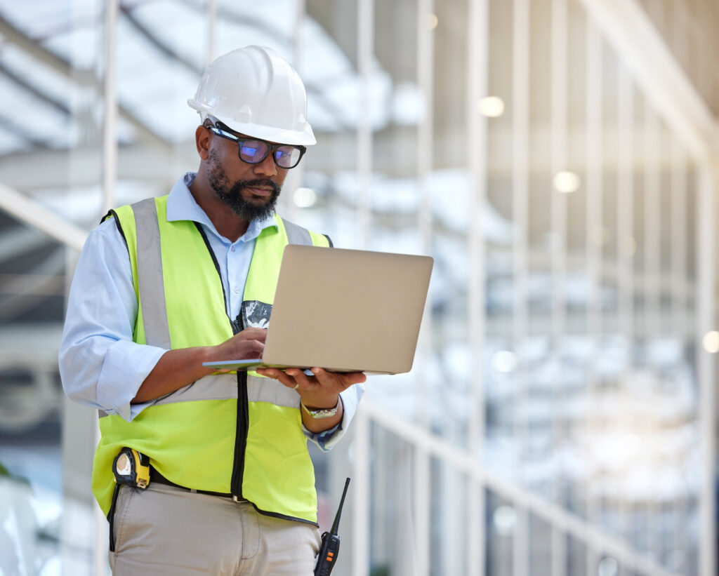 architecture research laptop with black man warehouse engineering building design technology planning digital with contractor focus project management graphic
